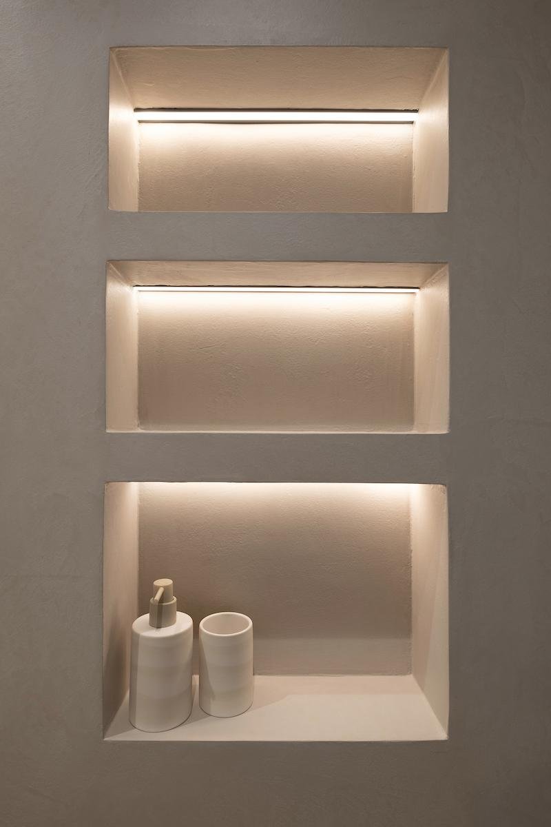 Recessed lit niches in microcement wall