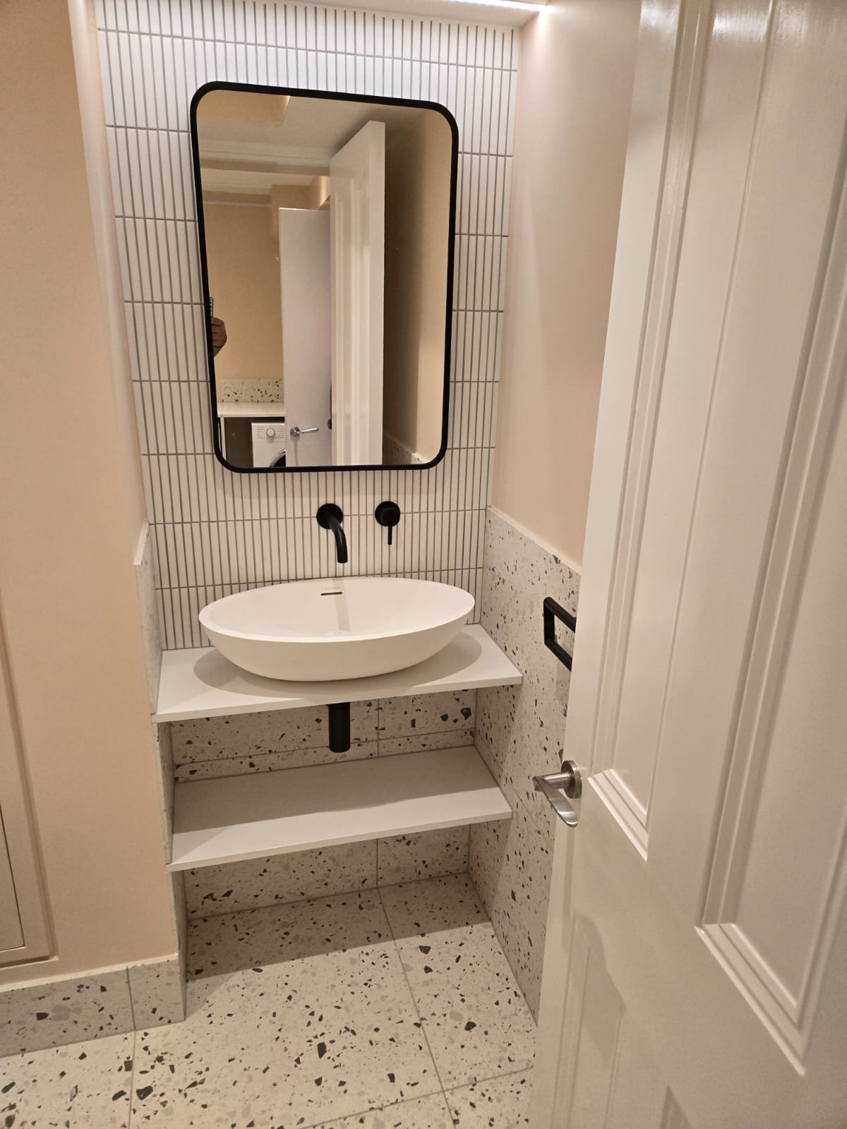 Cloakroom with terrazzo and kit-kat tiling